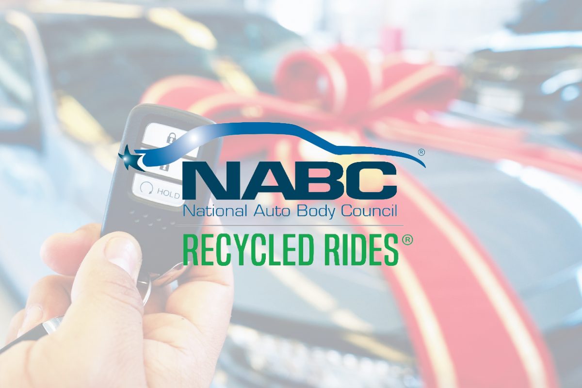 National auto body council logo in front of car with bow on it