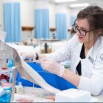 An A-State nursing student practices hands-on clinical skills during a simulation lab exercise.