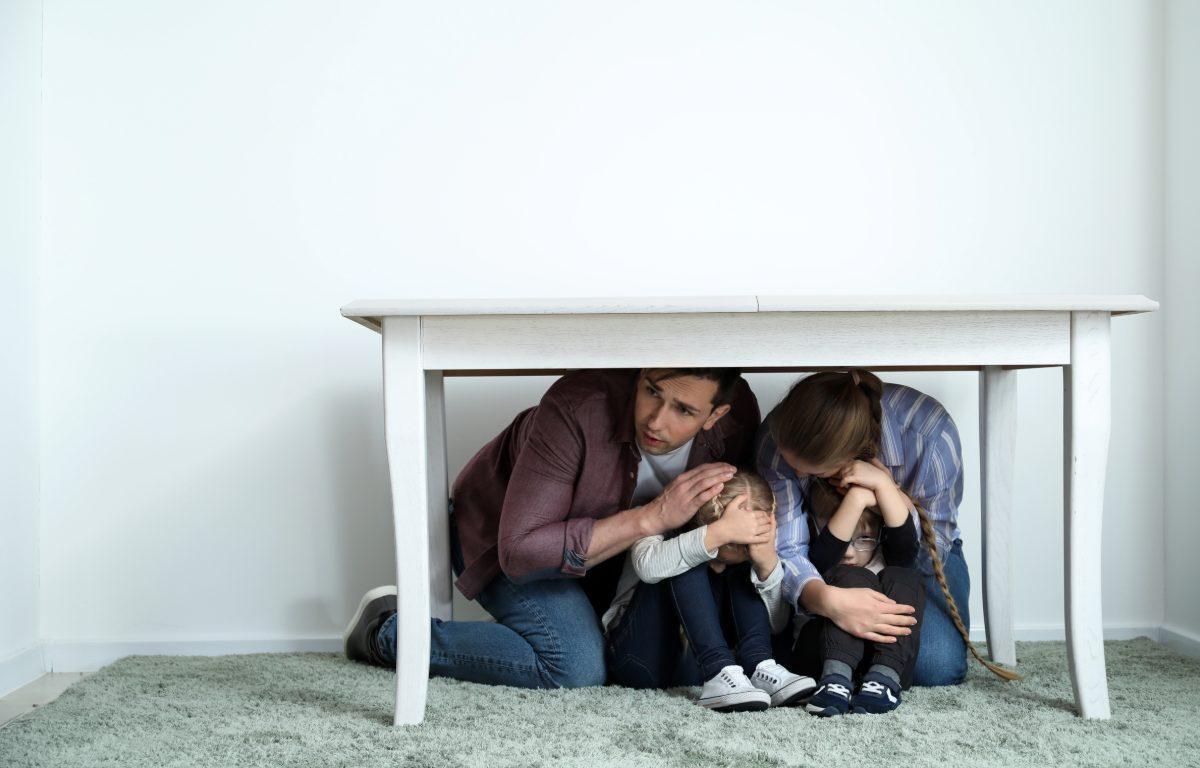 family hides under desk