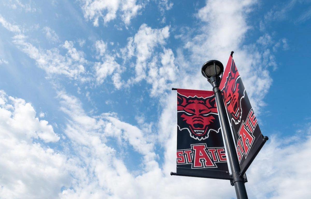 A-State flag on blue sky with clouds