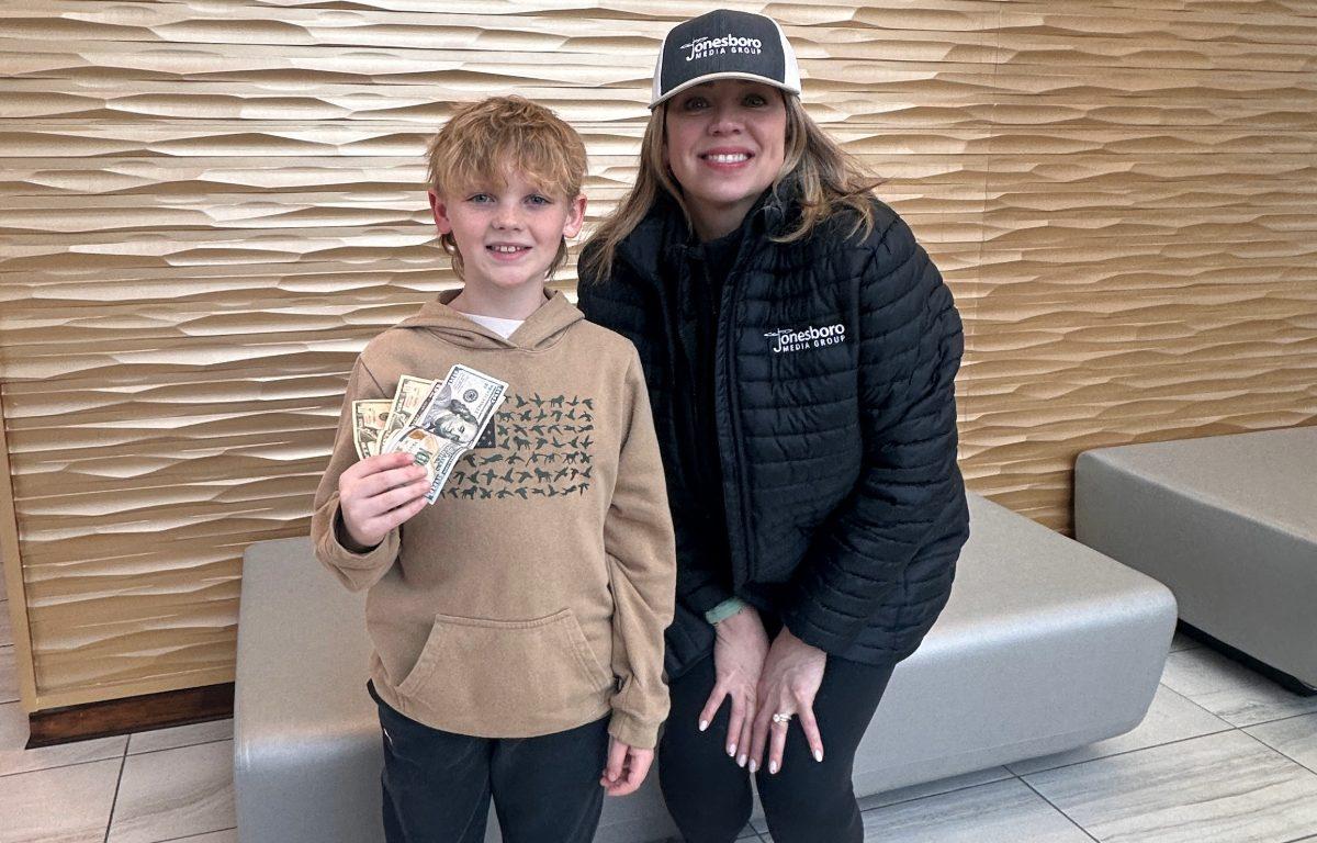 Matthews and Beeson posing while beeson holds money