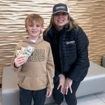 Matthews and Beeson posing while beeson holds money