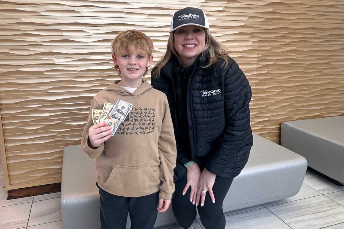 Matthews and Beeson posing while beeson holds money