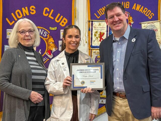 onesboro University Heights Lions Club First Vice President Deborah Levins (left) presents NYITCOM Student Doctor Karley Bloesch with a certificate recognizing her as the recipient of a newly-established scholarship the JUH Lions Club created to annually support an NYITCOM medical student. Joining Levins and Bloesch is Casey Pearce (far right), Director of External Relations for NYITCOM at A-State.