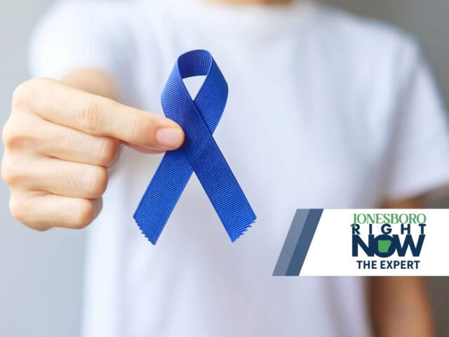 man holding dark blue ribbon for colorectal cancer