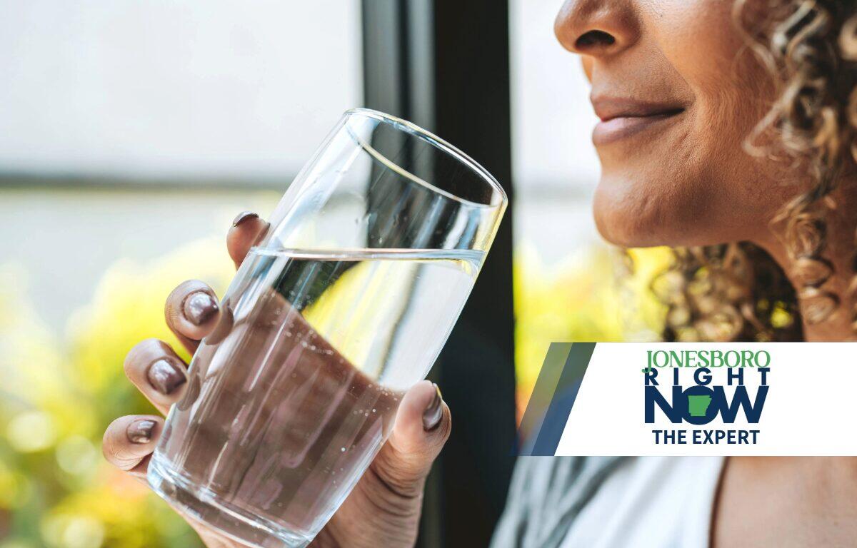 The Expert woman holding glass of clean water