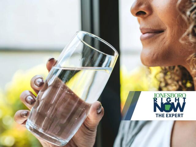 The Expert woman holding glass of clean water