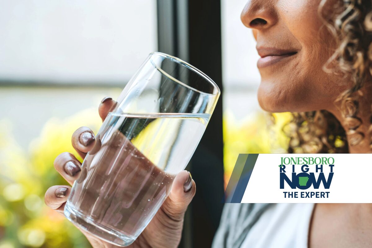 The Expert woman holding glass of clean water