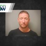 Mugshot photo of a man with short reddish hair and beard in a black shirt, against a gray background, with the Jonesboro Light Now logo in the top-left corner.