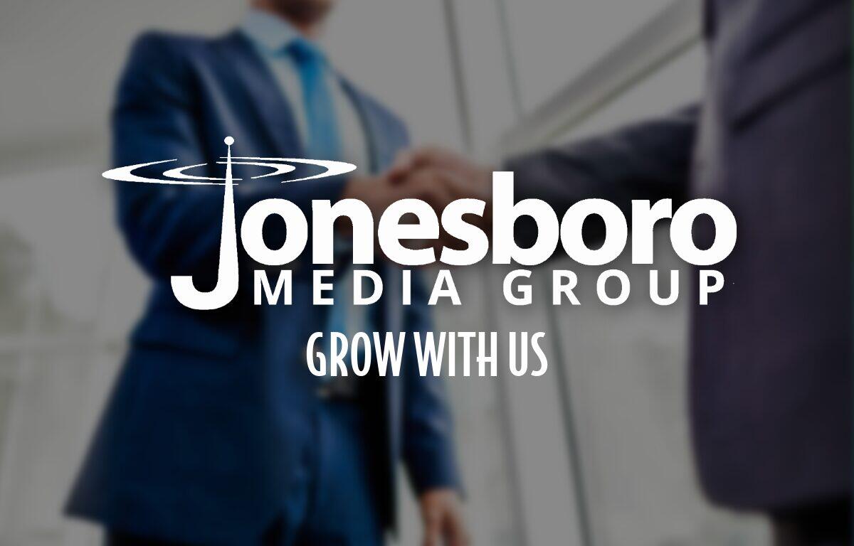 Two men shaking hands with logo in foreground