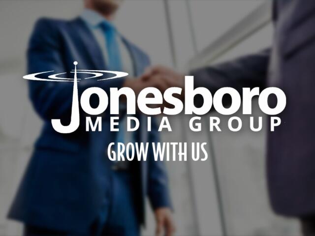 Two men shaking hands with logo in foreground