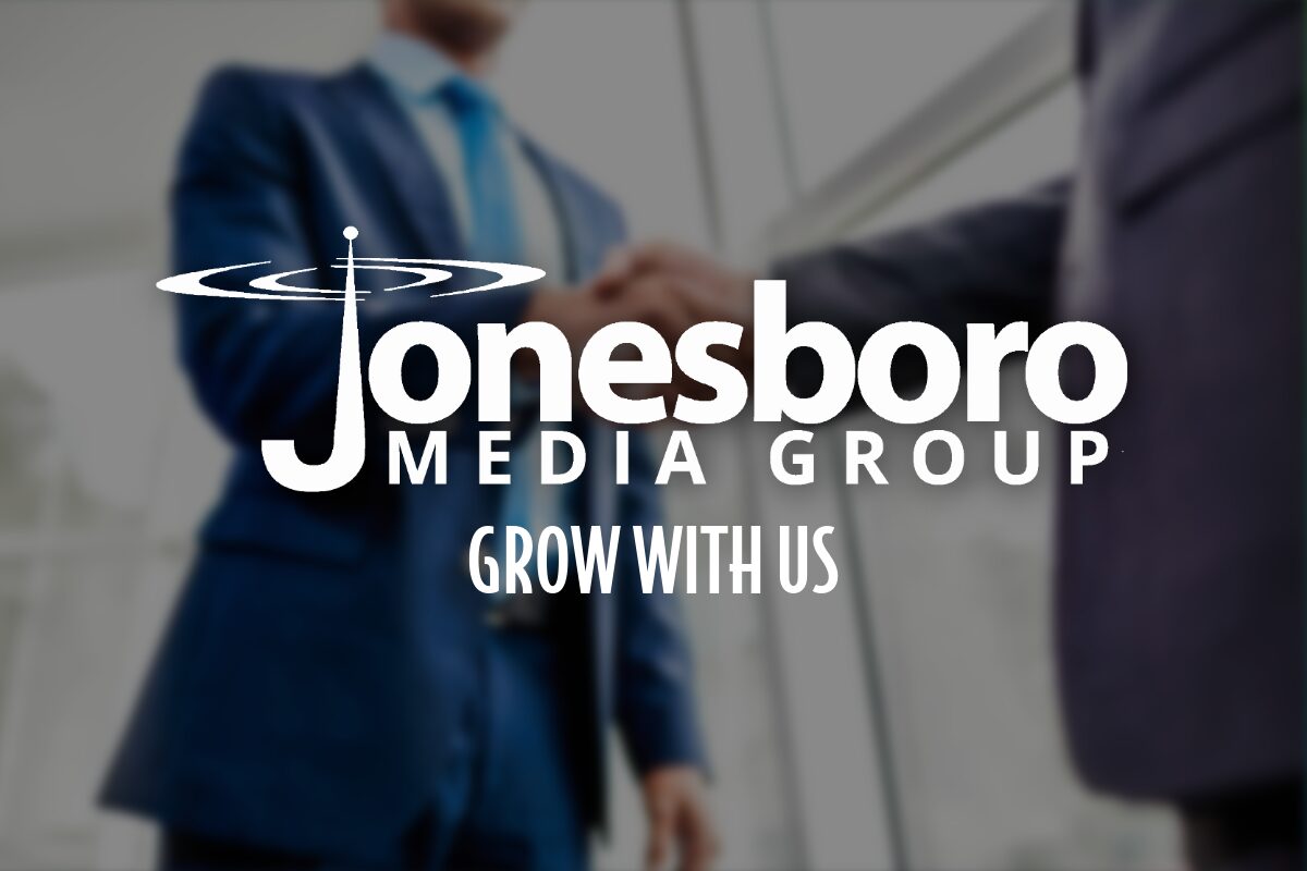 Two men shaking hands with logo in foreground