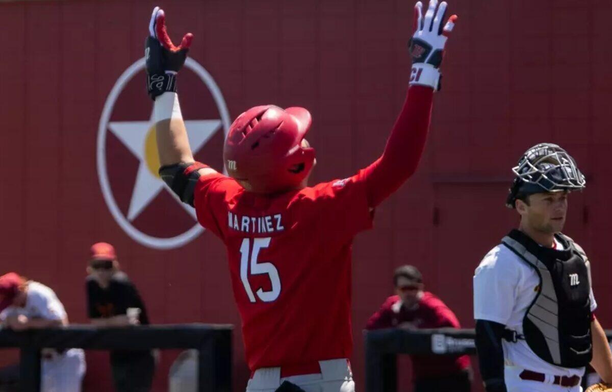baseball player with 15 on jersey throwing hands in air