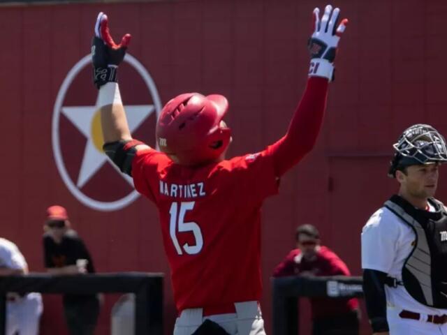 baseball player with 15 on jersey throwing hands in air