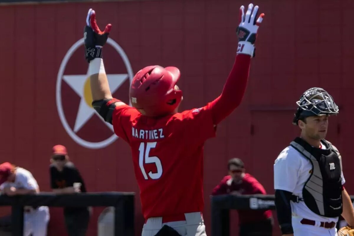 baseball player with 15 on jersey throwing hands in air