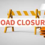 Road closure sign: orange barricade with traffic cones and a bold 'ROAD CLOSURE' text overlay; logo in the top-right corner.
