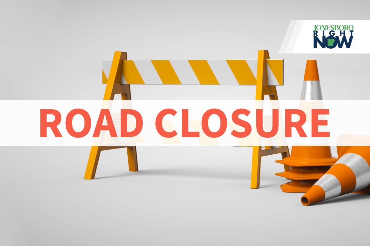 Road closure sign: orange barricade with traffic cones and a bold 'ROAD CLOSURE' text overlay; logo in the top-right corner.