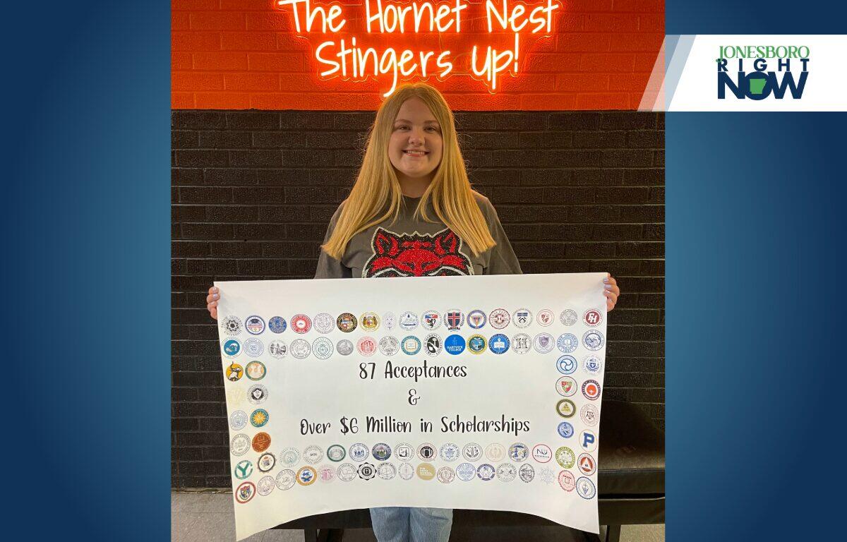 blonde girl from harrisburg holds poster showing college acceptance
