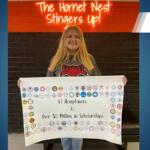 blonde girl from harrisburg holds poster showing college acceptance