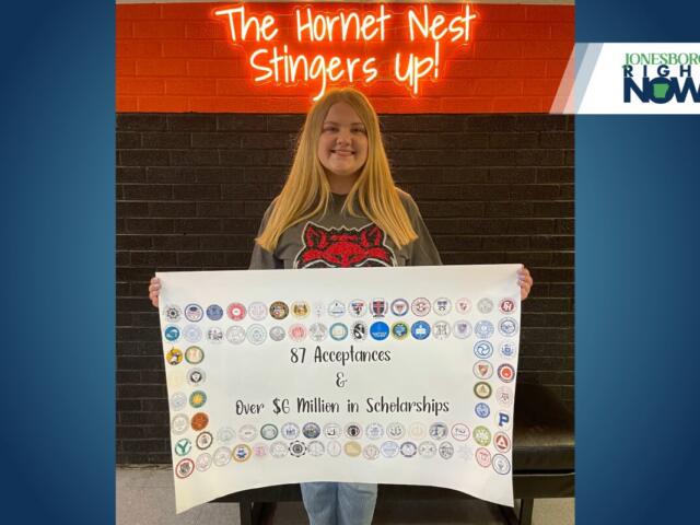 blonde girl from harrisburg holds poster showing college acceptance