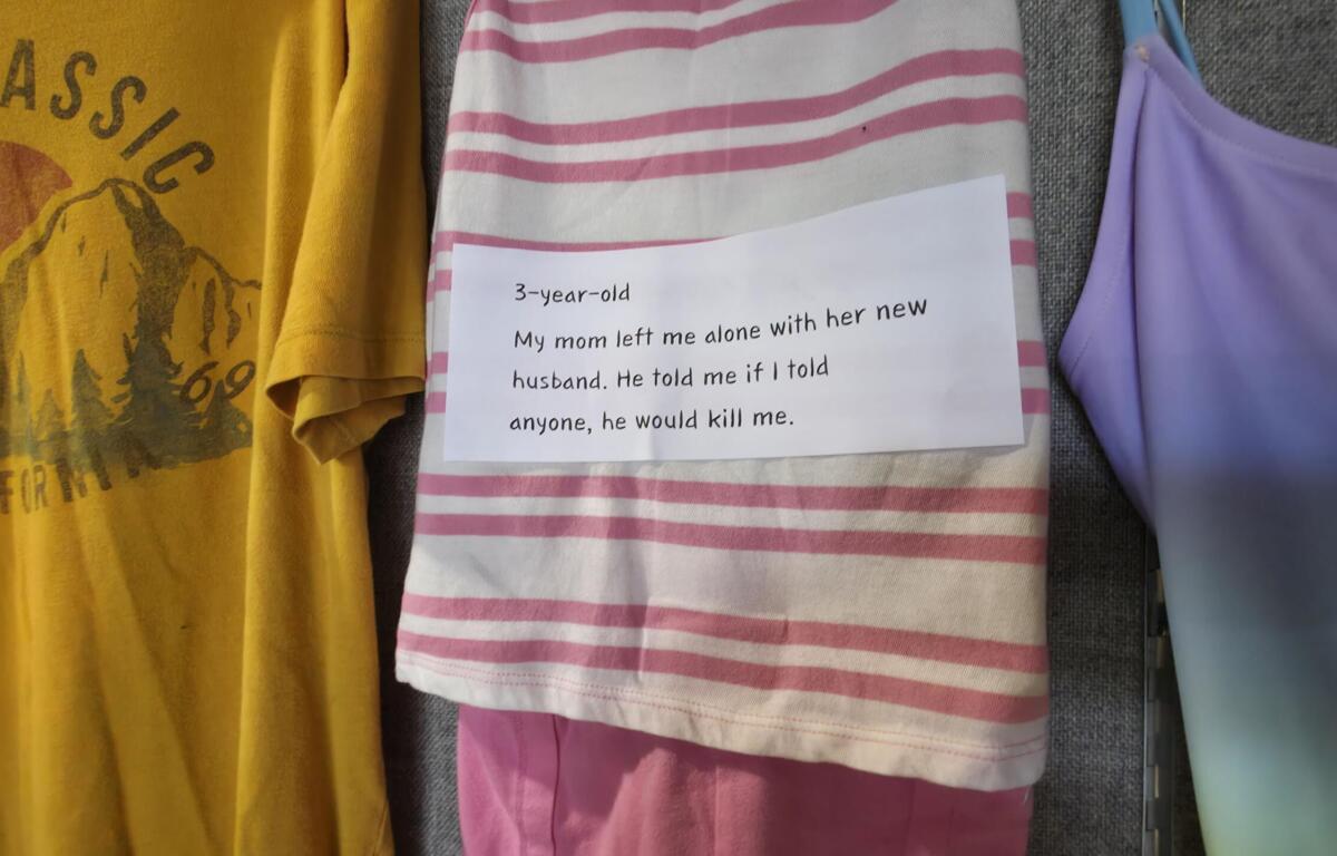 Center image shows a pink-and-white striped shirt with a handwritten note about a 3-year-old being harmed by her mom's new husband; note says not to tell anyone or there would be harm. A yellow graphic tee is on the left and a purple top on the right.