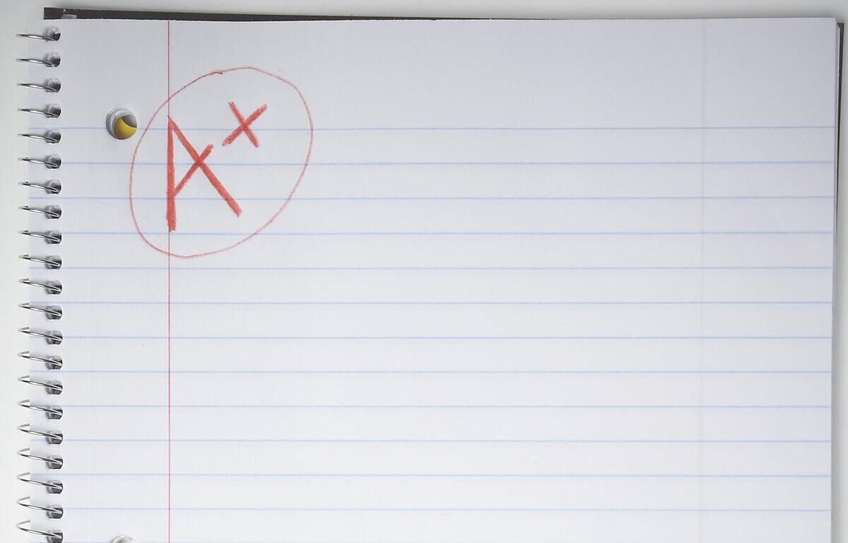 Red pen annotation on a spiral notebook page: letters 'A' and 'X' circled in red ink.