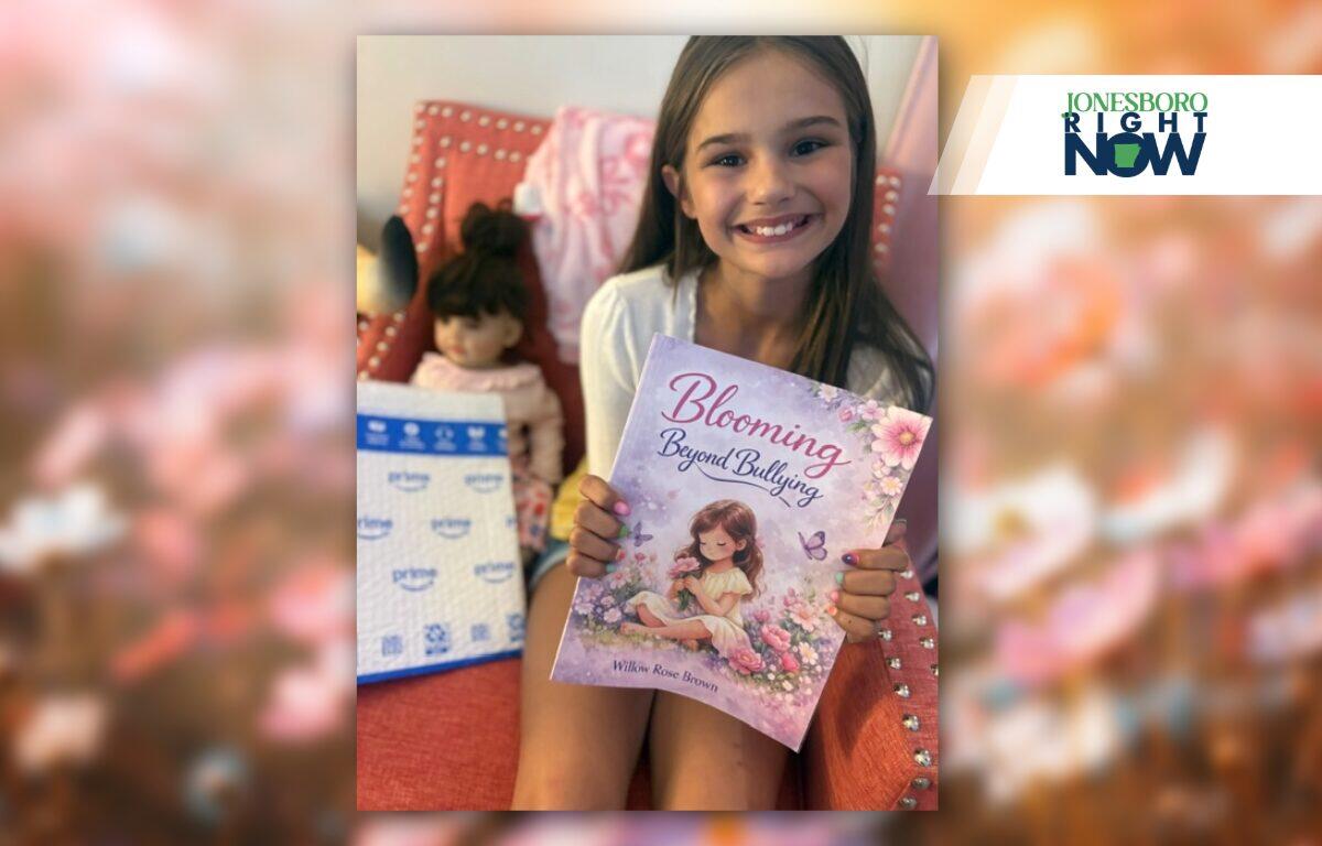 little girl holding blooming beyond bulling book