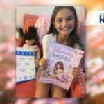 little girl holding blooming beyond bulling book