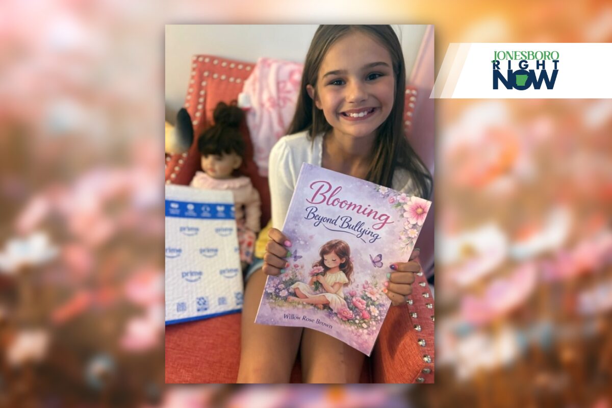 little girl holding blooming beyond bulling book