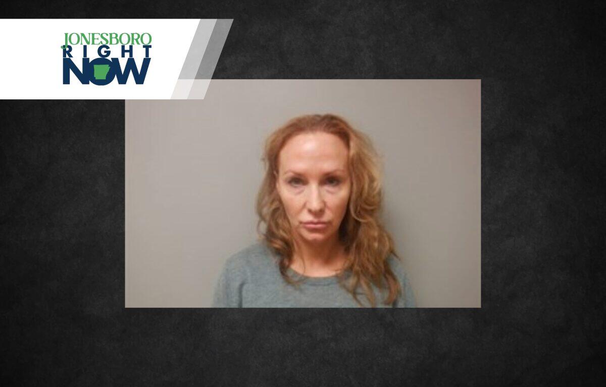 Mugshot-style photo of a woman with wavy blonde hair wearing a gray top and a neutral expression against a plain wall, with Jonesboro Right Now branding in the corner.