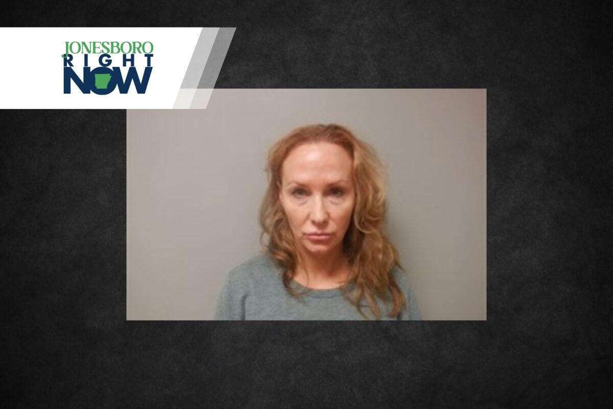Mugshot-style photo of a woman with wavy blonde hair wearing a gray top and a neutral expression against a plain wall, with Jonesboro Right Now branding in the corner.