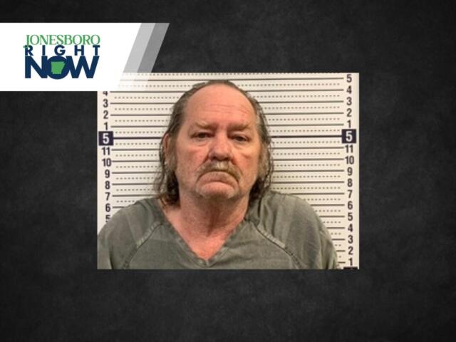 Mugshot of a middle-aged man with long gray hair in front of a height-chart backdrop, with a Jonesboro Right Now logo overlayed in the top-left.