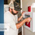 Man installing AED at school