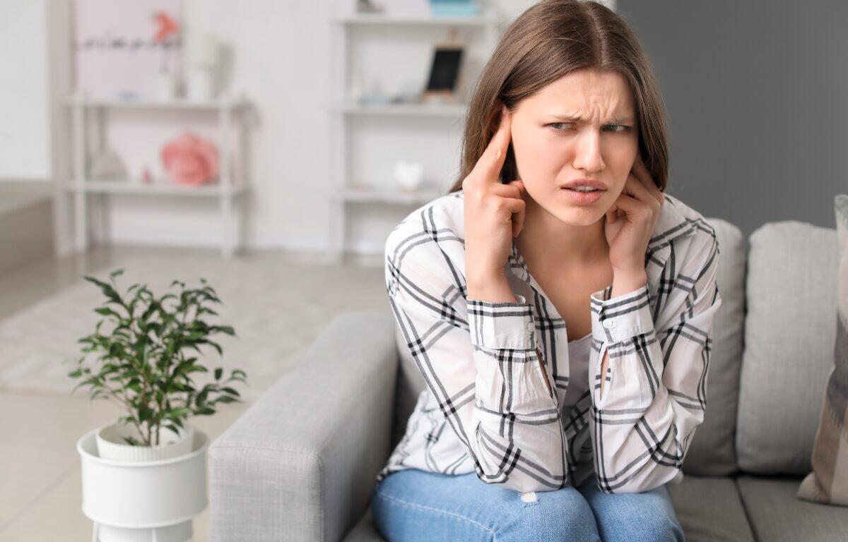 woman on couch loud noise