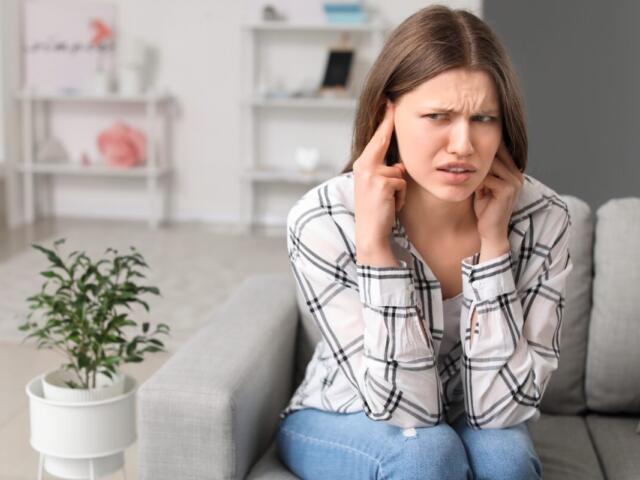 woman on couch loud noise