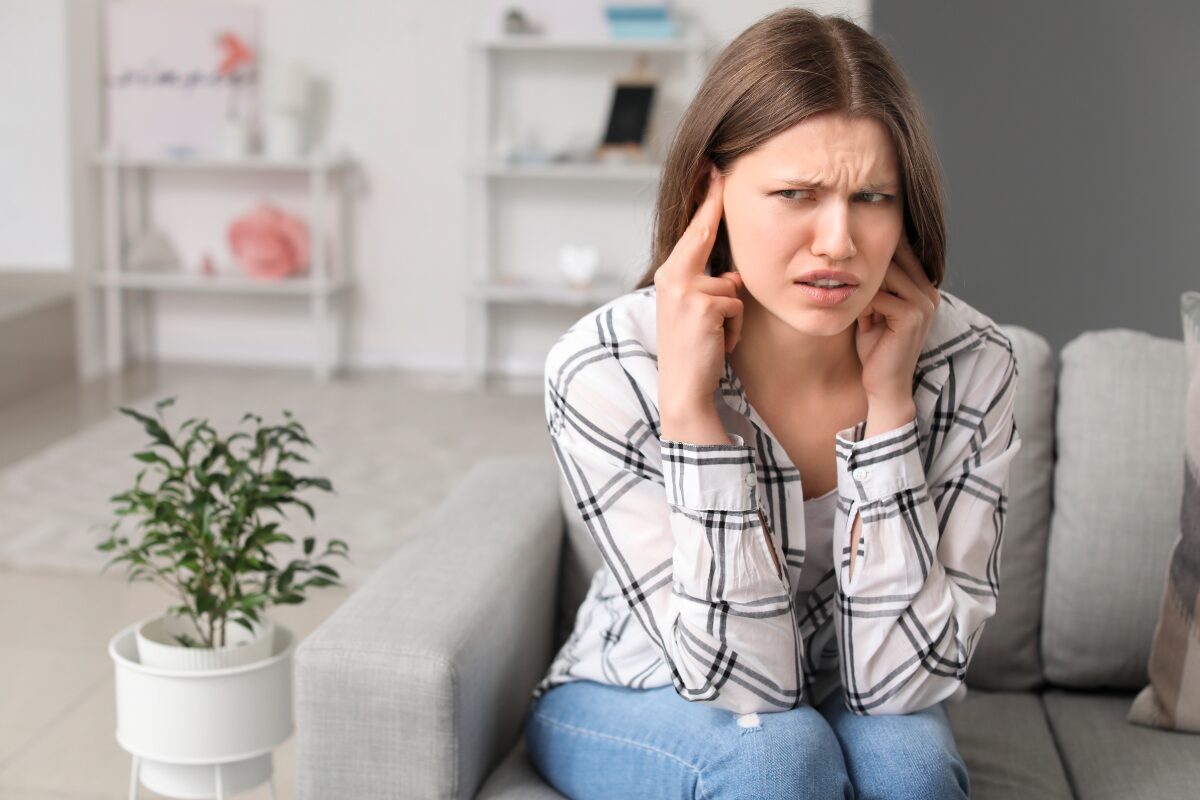woman on couch loud noise