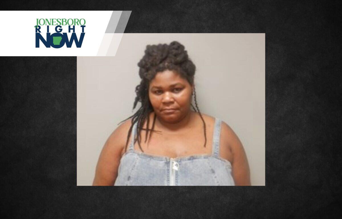 Mugshot-style photo of a woman with braided hair wearing a light denim top, neutral background, with a Jonesboro Right Now banner in the top-left corner.