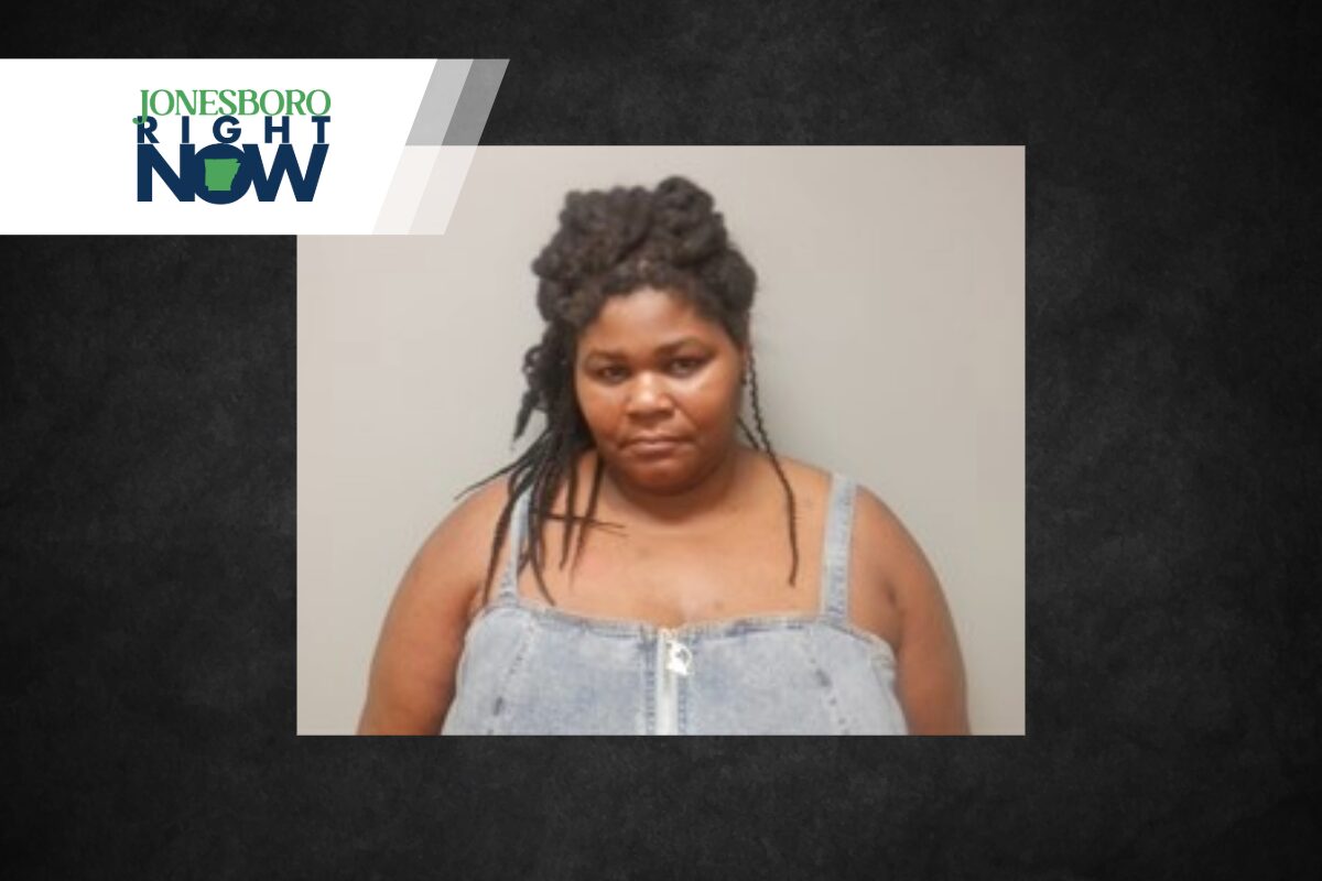 Mugshot-style photo of a woman with braided hair wearing a light denim top, neutral background, with a Jonesboro Right Now banner in the top-left corner.