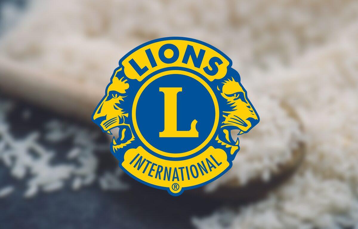 Lions Clubs International emblem in blue and gold centered on a blurred background.