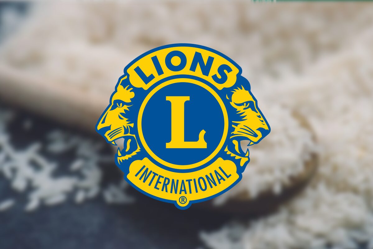 Lions Clubs International emblem in blue and gold centered on a blurred background.