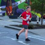 teenage boy runs through streets in running gear