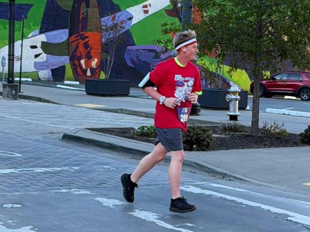 teenage boy runs through streets in running gear