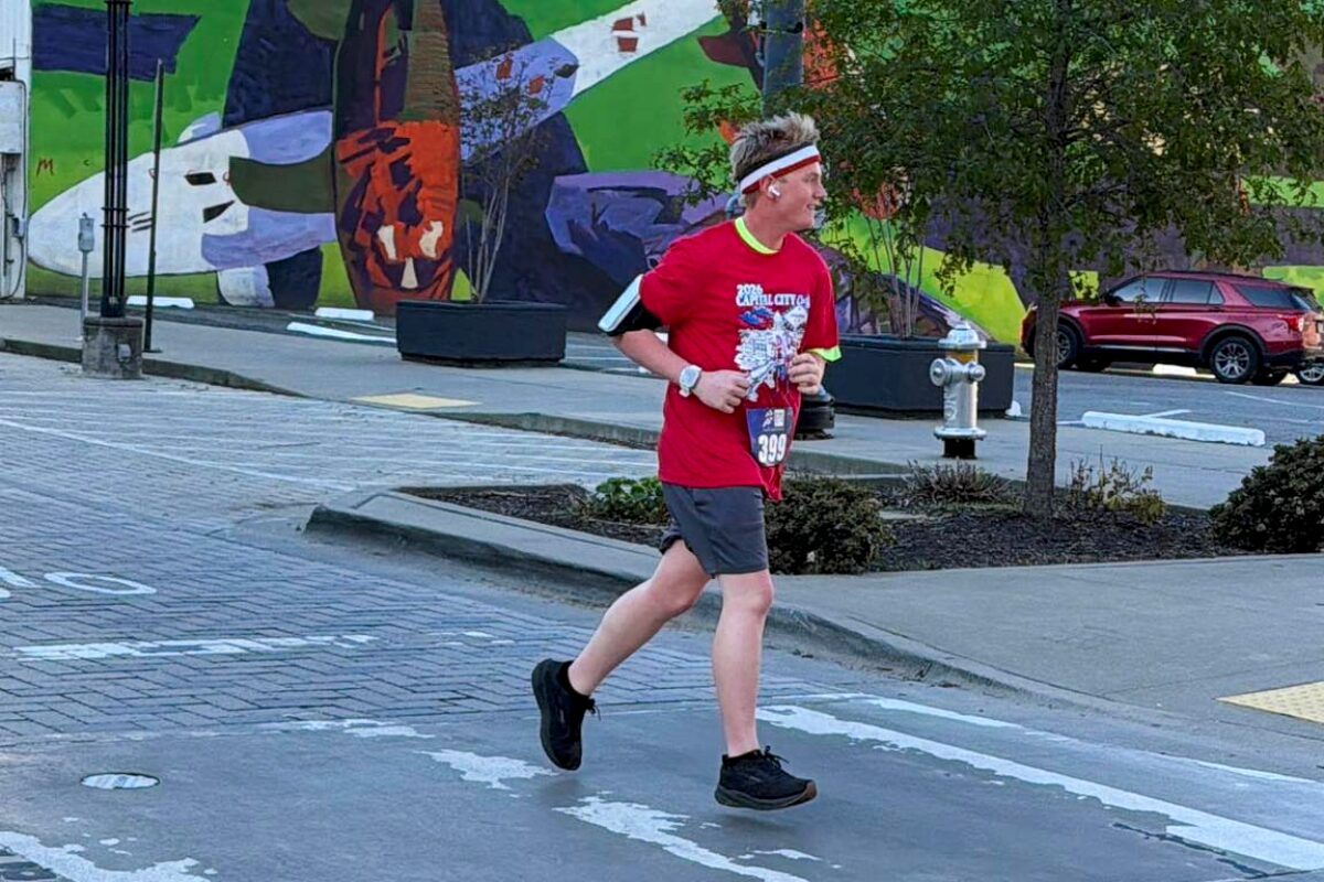 teenage boy runs through streets in running gear