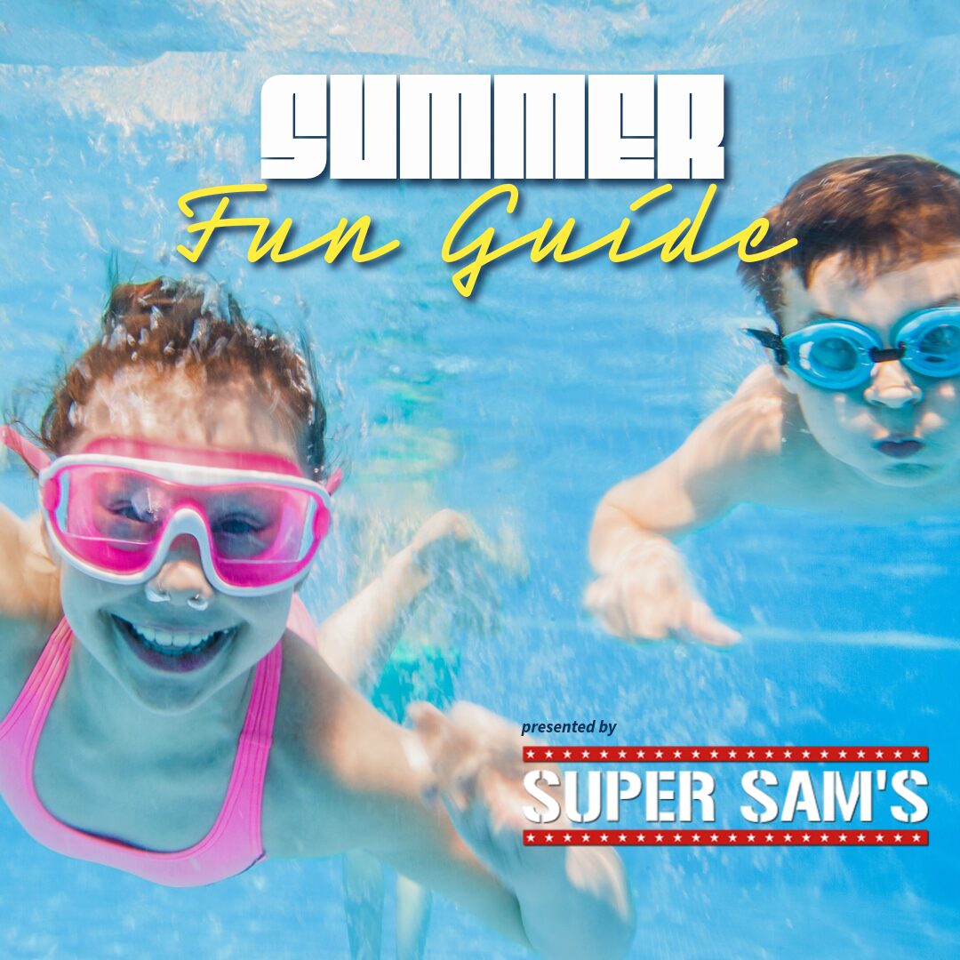 Underwater photo of a smiling girl with pink goggles and a boy with blue goggles, advertising a 'Summer Fun Guide' presented by Super Sam's.