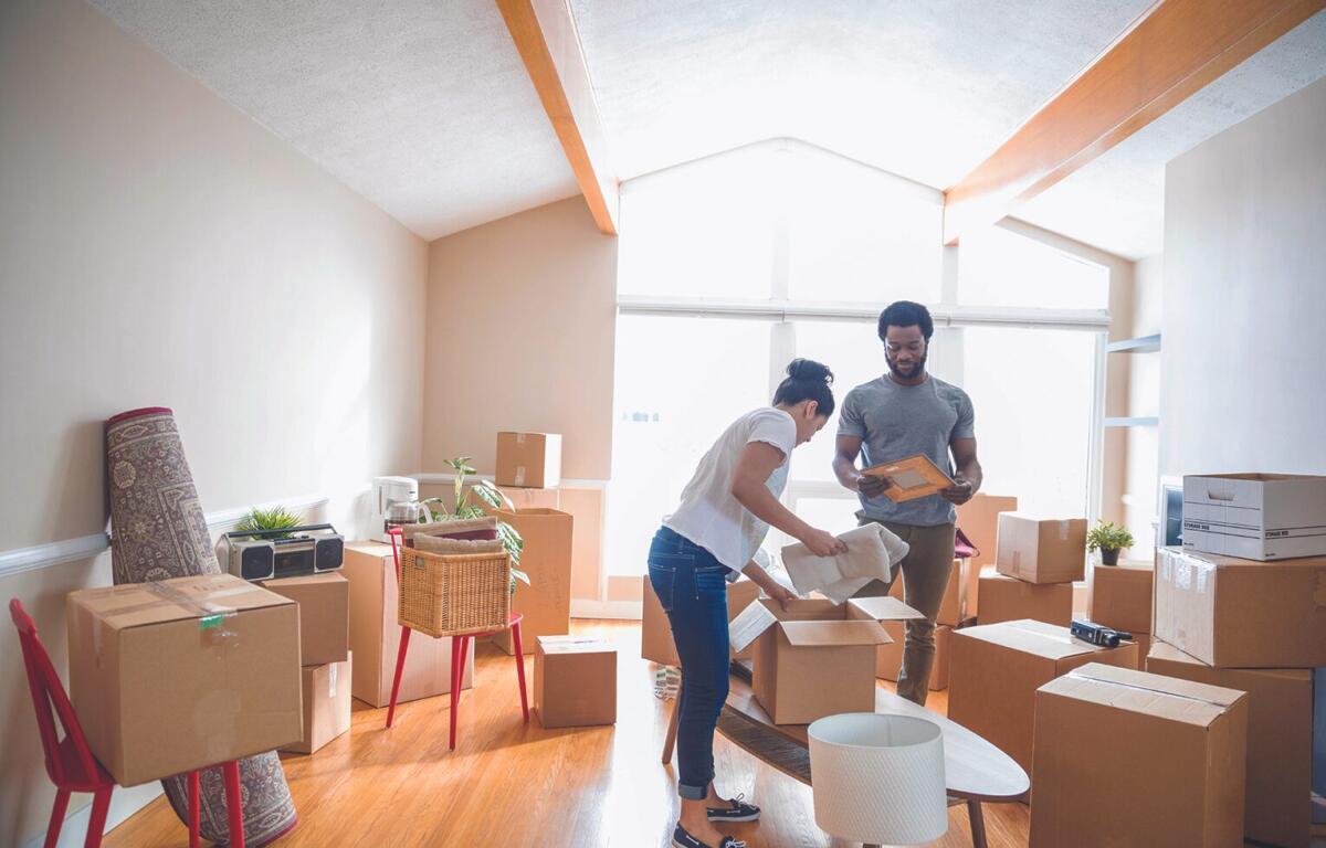 couple in room surrounded by boxes