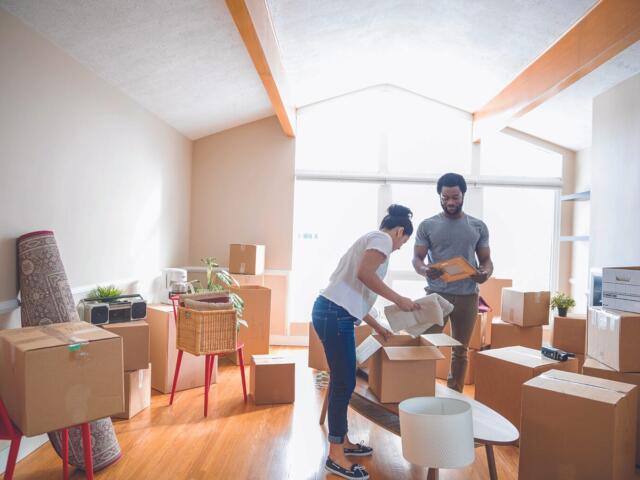 couple in room surrounded by boxes
