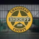 Circular gold Craighead County sheriff badge with a five-point star, a black 'SHERIFF' banner, and the year 1859.