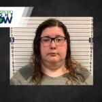 Mugshot-style photo of a woman with glasses in front of a height chart; Jonesboro Right Now logo in the corner