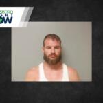 Mugshot-style photo of a bearded man in a white tank top, standing against a plain grey wall, with a Jonesboro Right Now logo in the top-left corner.