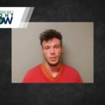 Mugshot-style photo of a young man wearing a red shirt against a gray wall, with a Jonesboro Right Now news banner in the corner.